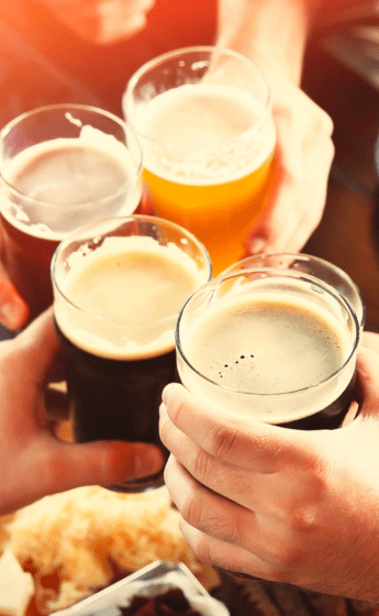 Four craft beers being held together.